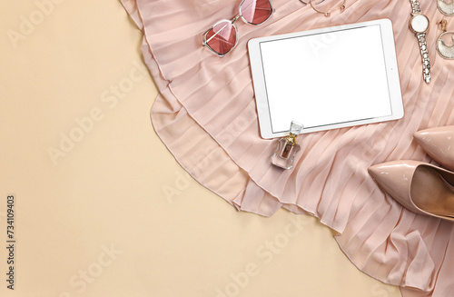 Flat lay composition with modern tablet on beige background. Space for text © New Africa