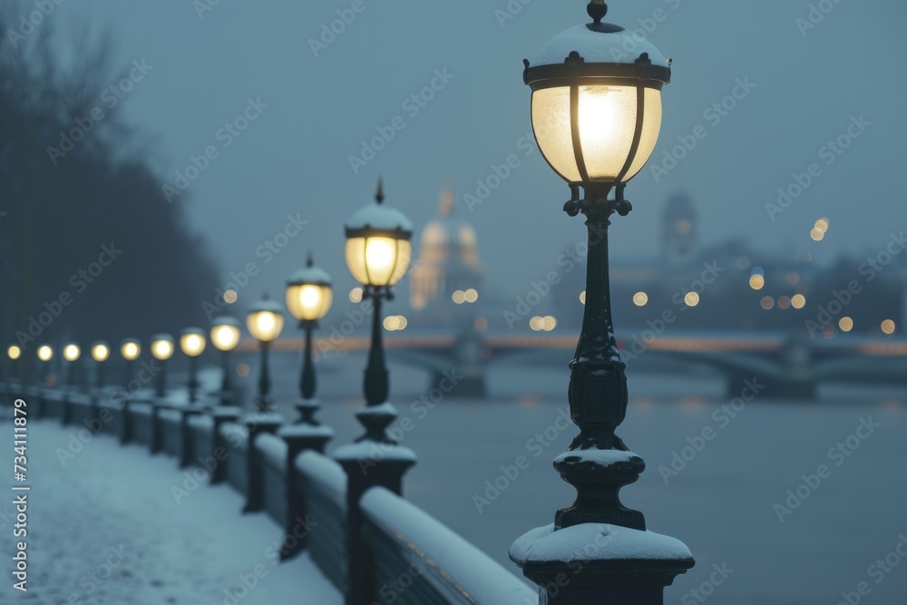 A row of street lights sitting next to a river. Perfect for urban landscapes and cityscapes
