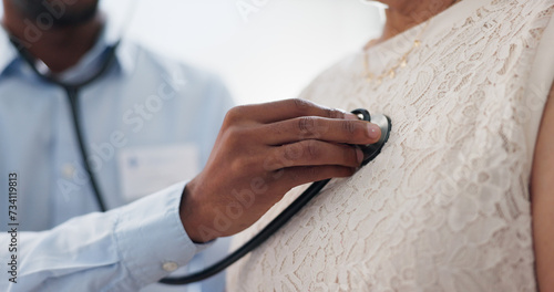 Hand, chest and stethoscope, doctor and patient for healthcare, cardiology and listening to heart at clinic. Medical exam for diagnosis, monitor heartbeat and people in consultation with health photo
