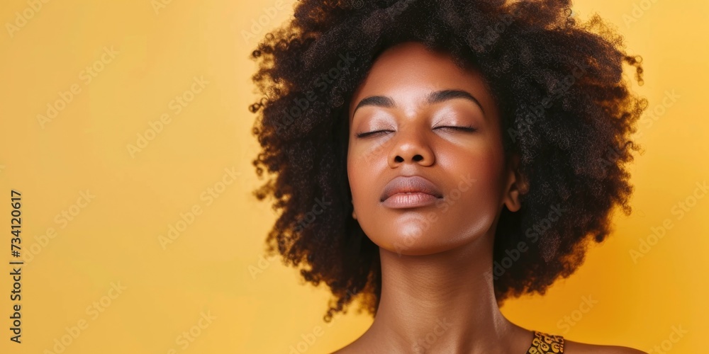A woman with her eyes closed. Can be used to portray relaxation, meditation, or peacefulness A woman with her eyes closed. Can be used to portray relaxation, meditation, or peacefulness