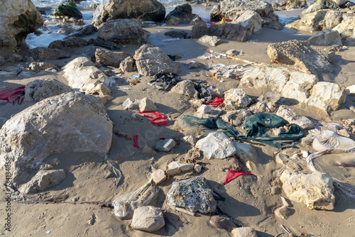 Garbage washed ashore after a storm. Pieces of cloth and plastic bags. Environmental pollution washes ashore Bat Yam Israel Winter