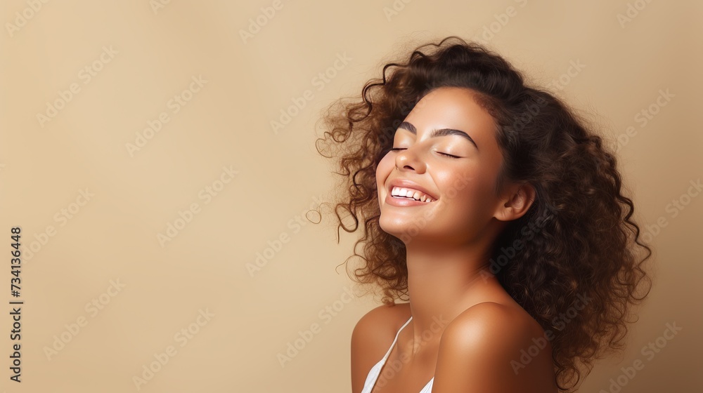 Portrait of smiling girl enjoying beauty treatment on beige background. Beautiful natural woman looking at copy space, spa and wellness concept. Carefree laughing woman with bare shoulders isolated. - obrazy, fototapety, plakaty 