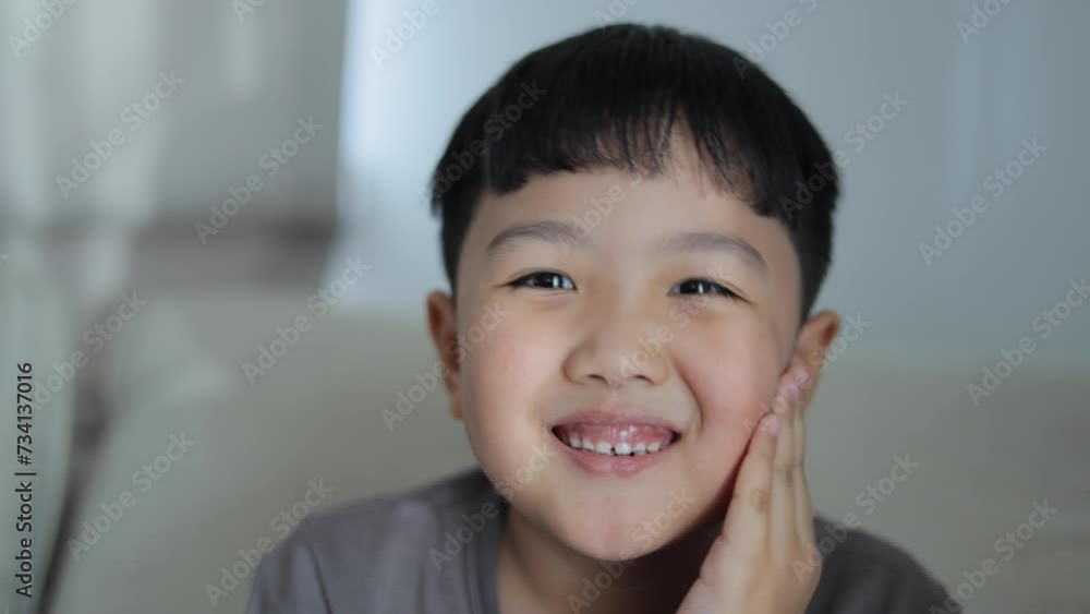 Child looking at camera smiling with happiness Child looking at camera smiling with happiness