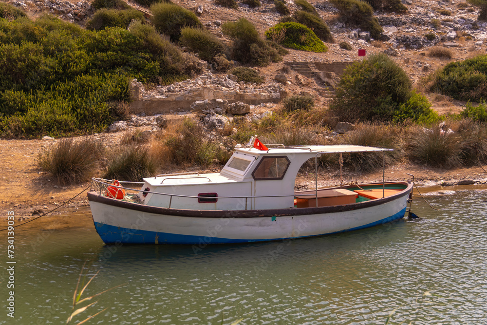 Close-up of a small wooden boat parked on a river on a sunny day, Turkey. Fishing boat parking Close-up of a small wooden boat parked on a river on a sunny day, Turkey. Fishing boat parking