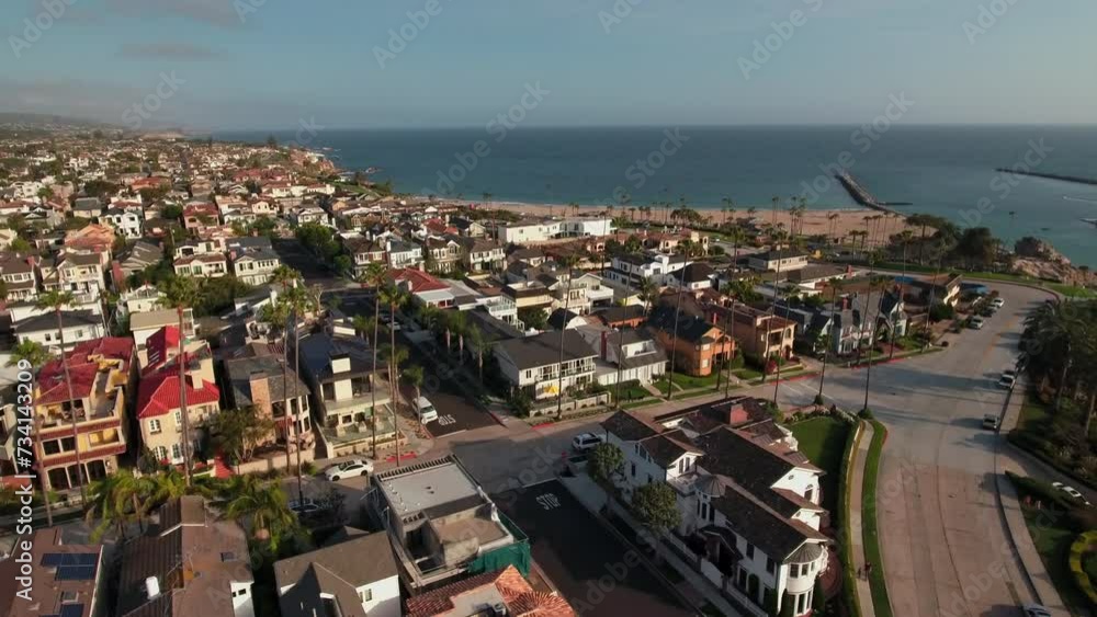 Aerial Scenic Shot Of Residential Roofed Houses On City Landscape By Sea, Drone Flying Backwards During Sunny Day - Newport Beach, California Aerial Scenic Shot Of Residential Roofed Houses On City Landscape By Sea, Drone Flying Backwards During Sunny Day - Newport Beach, California