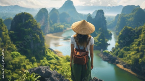 A young woman stands with her back and admires the view of the Asia. A traveler traveling on vacation in the most beautiful place in the world. Summer vacation photo