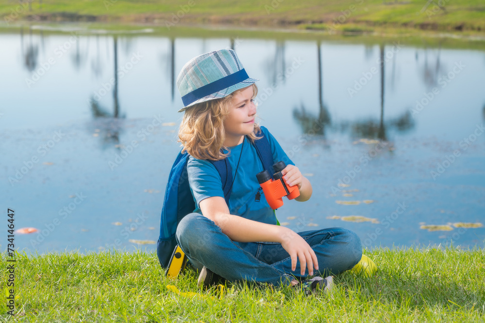 Travel and adventure concept. Little child boy tourist explorer with binoculars on nature. Discovery, exploring and education. Travel and adventure concept. Little child boy tourist explorer with binoculars on nature. Discovery, exploring and education.