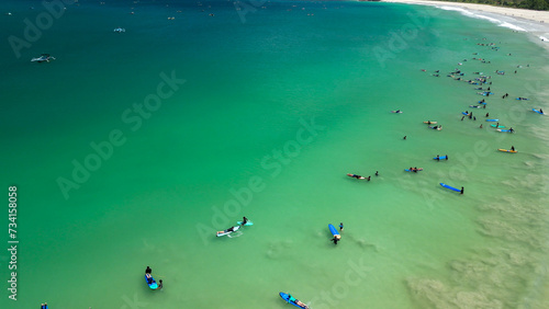 Aerial view of Surfers finding waves in Lombok, Indonesia