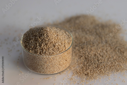 Closeup of little millet grains in a glass bowl filled to the brim photo