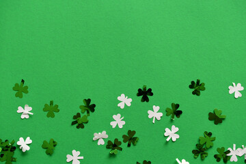 Saint Patrick's Day green background with green and white shamrock or four-leaf clover confetti, St. Patty's Day