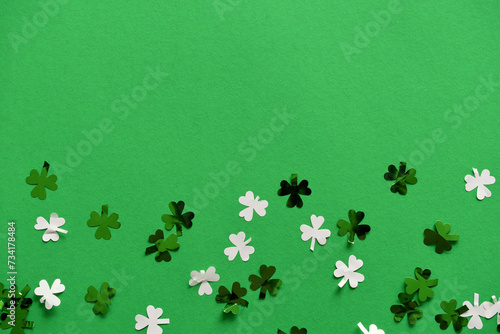 Cuadro en lienzo Saint Patrick's Day green background with green and white shamrock or four-leaf clover confetti, St