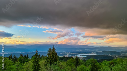 Scenic sunset view of Lake Faak seen from Altfinkenstein at Baumgartnerhoehe, Carinthia, Austria. Tranquil atmosphere on hiking trail in spring. Overlooking Villach area surrounded by Austrian Alps photo