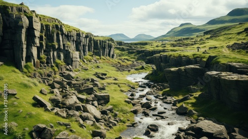 A river cuts through a valley filled with rich green foliage, creating a tranquil scene.