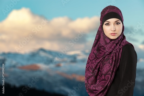 Muslim arab woman posing on sky background © BillionPhotos.com