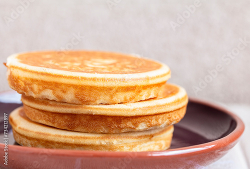 Golden pancakes in close-up on a gray background