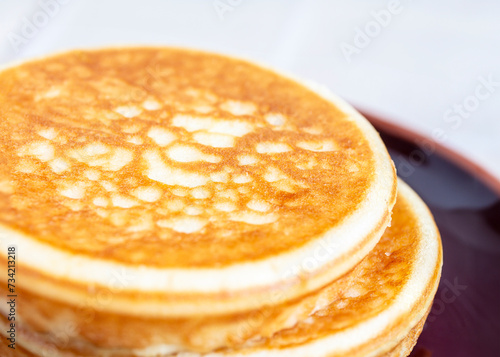 Stack of pancakes isolated on light background