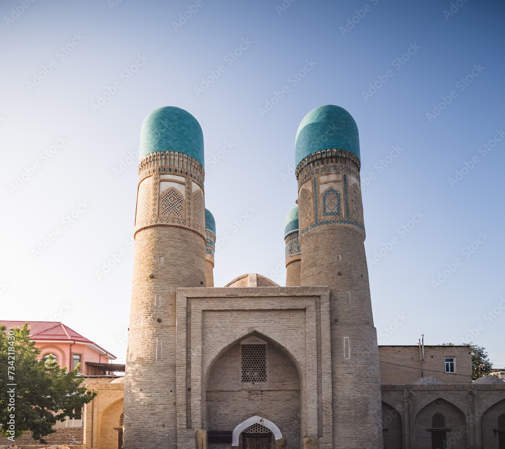 Exterior of Chor Minor Madrasah in the ancient city of Bukhara in Uzbekistan, oriental architecture at sunset in the evening