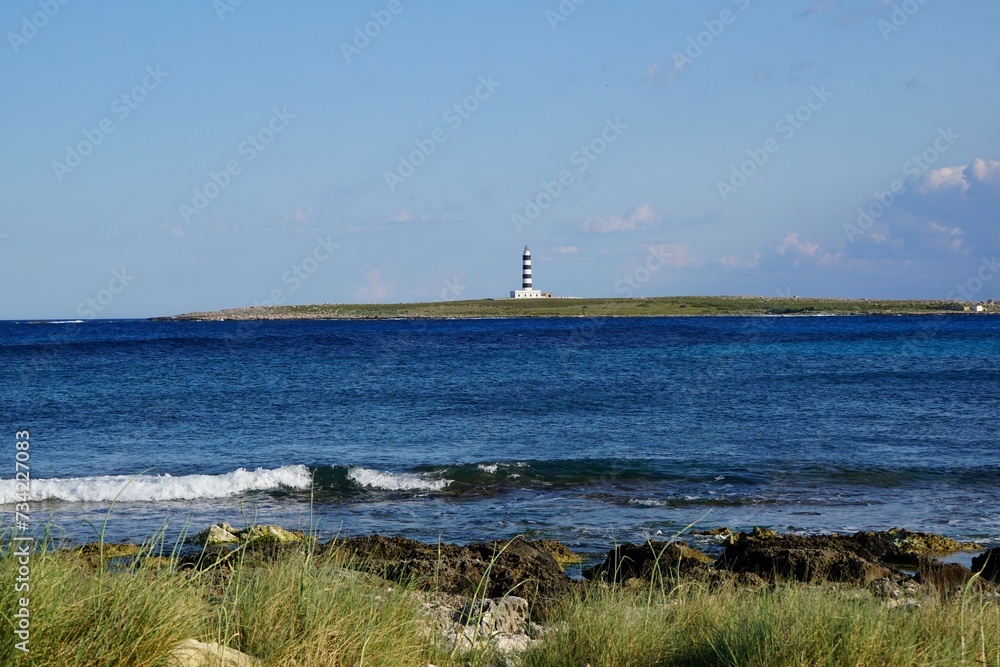 A lighthouse on a landmark in the mediterranean ocean of Menorca