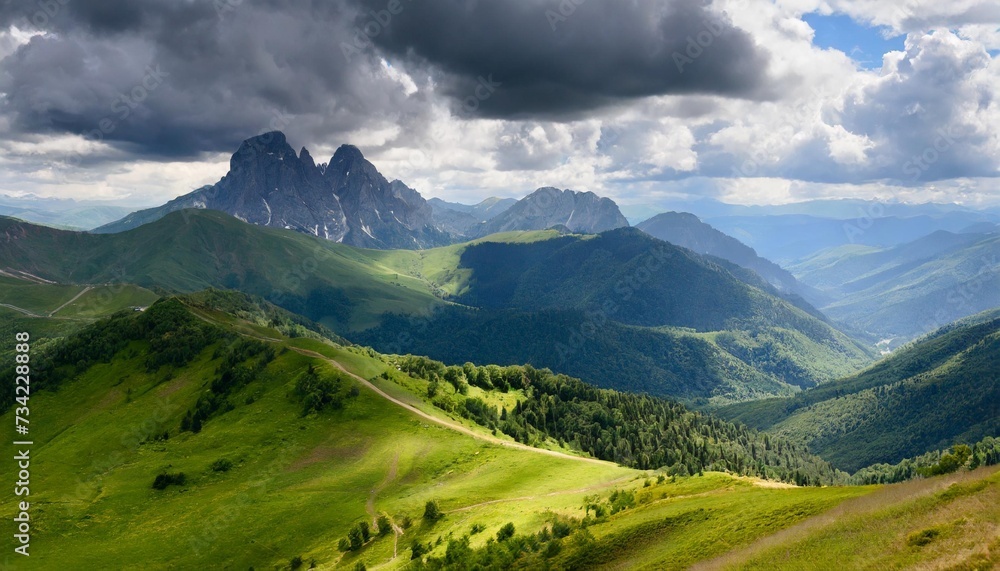 beautiful mountain ranges and peaks with forests and meadows against a stormy sky with clouds