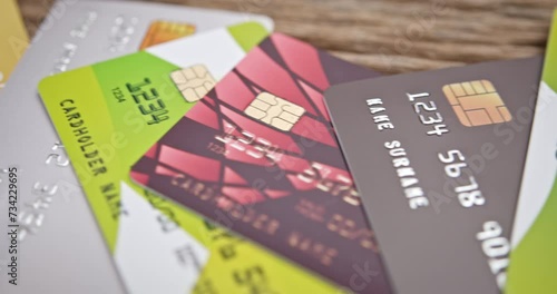 Credit card debt, electronic fund transfer, unsecured consumer debt and personal finance concept : A sweeping panoramic perspective capturing a collection of assorted credit cards gathered in a pile.