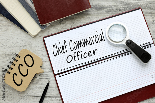 Fotografia wooden table with diary with text COO Chief Commercial Officer