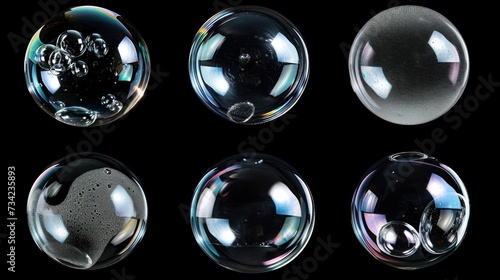  a group of soap bubbles sitting next to each other on top of a black surface with different shapes and sizes of soap bubbles on top of each of the bubbles.