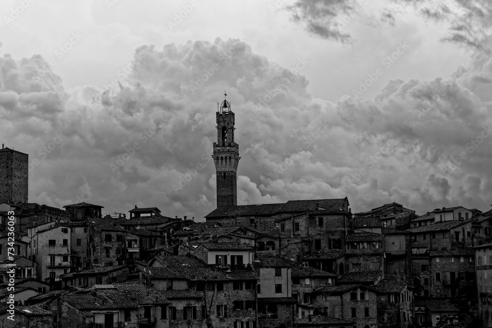 Obraz premium Siena Italy 09 30 2022: Old Medieval city in Tuscany in Europe. Art and culture. Tourists from all over the world for Piazza del Campo Palio Duomo Tower del Mangia and the oldest bank banco dei Paschi