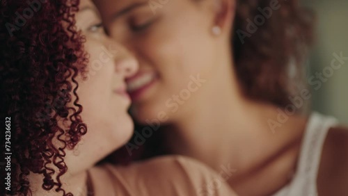 Lesbian couple lying on sofa, hugging and stoke tender each other. Young female couple in romantic relationship enjoy love moments. Closeness concept
 photo