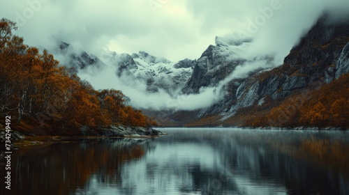  a body of water surrounded by mountains with trees in the foreground and clouds in the sky over the water and in the distance, there is a body of water that is a.