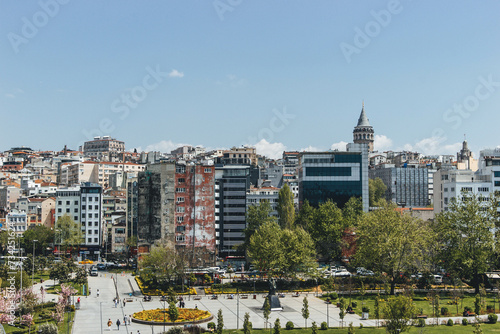 view of district galata tower in bosphorus strait magnific city istanbul with boats passing by and huge mosquee on top of hill photo