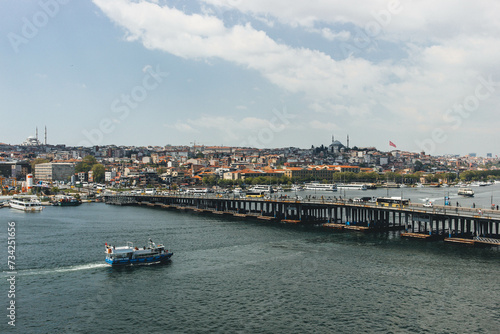 landscape view of bosphorus strait magnific city istanbul with boats passing by and huge mosquee on top of hill photo