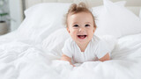 Childcare Concept. Portrait of cute little American baby wearing bodysuit lying on white beedsheets at home. infant child crawling on bed in the bedroom. Selective focus, free copy space
