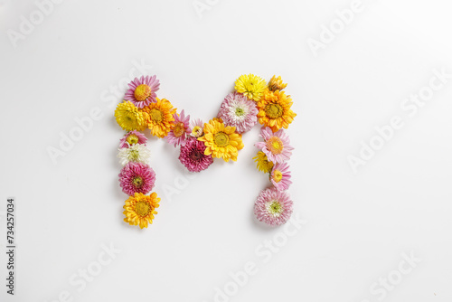 Letter M made of real natural flowers.