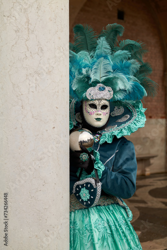 Fototapeta Naklejka Na Ścianę i Meble -  Venice, Italy - February 2022 - carnival masks are photographed with tourists in San Marco square