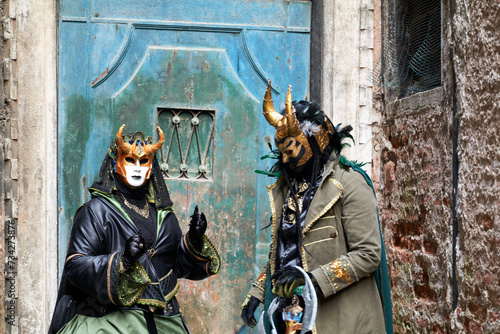 Venice, Italy - February 2022 - carnival masks are photographed with tourists in San Marco square © Renato68
