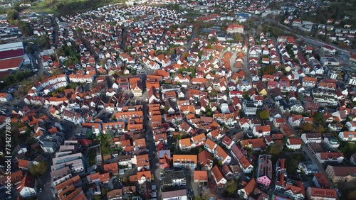 Aerial around the old town of the city Metzingen in Germany on a afternoon in autumn. photo