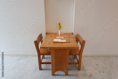 A desk, chairs and glasses for a couple with mimosa