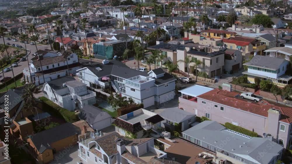 Aerial Panning Scenic Shot Of Roofed Houses In City Against Sky On Sunny Day - Newport Beach, California