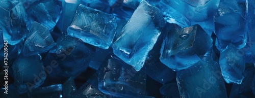 A detailed view of a pile of closely-packed blue ice cubes, showcasing their texture and color.