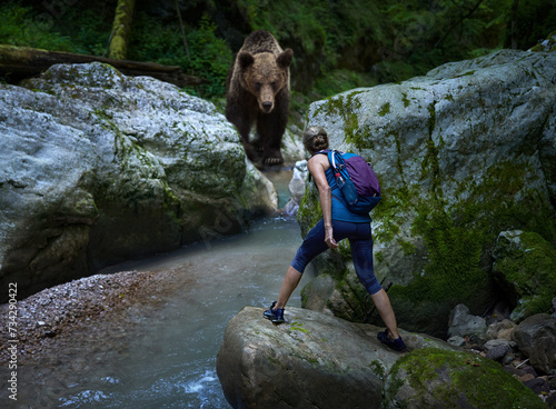 Obraz na plátne Woman hiker face to face with a grizzly bear in a canyon