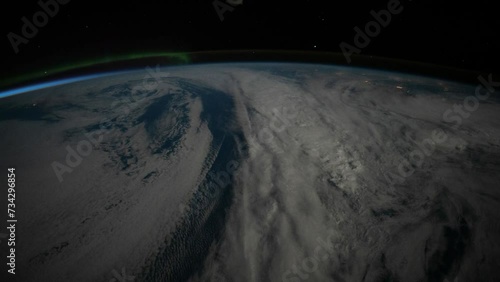 Nocturnal flight over the north Atlantic and Europe with Aurora Borealis. As seen from the International Space Station. Elements of this image furnished by NASA. Corrected for flickering.