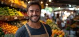 Young bearded happy man with paper package of vegetables groceries