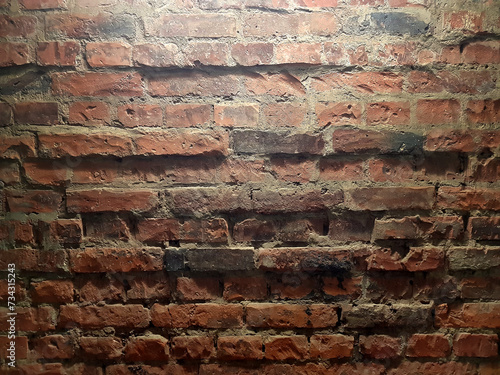 Red brick wall texture background with spotlight.