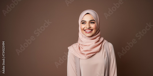Confident young woman in pink hijab, studio portrait, plain background. Fashion and culture concept Generative AI