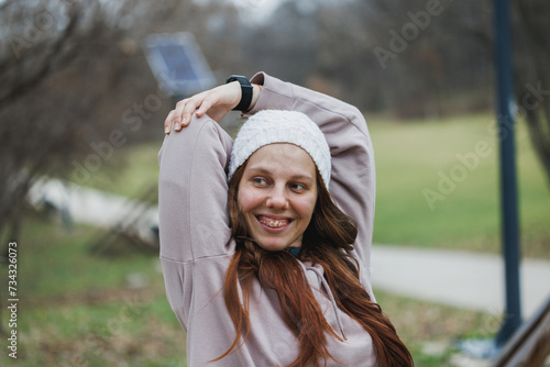 Woman With Braces Stretching in a Park During an Autumn Afternoon