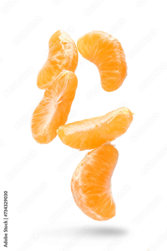 Peeled flying tangerine segments on white background Peeled flying tangerine segments on white background