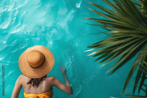 a woman in a swimsuit and hat in a pool © Veronica