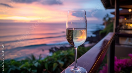 Closeup of a glass of wine on the balcony of a tropical resort, overlooking the ocean, generative ai