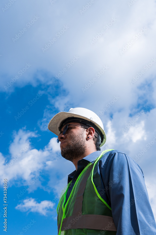 Construction worker man portrait in construction site in sunny day Construction worker man portrait in construction site in sunny day
