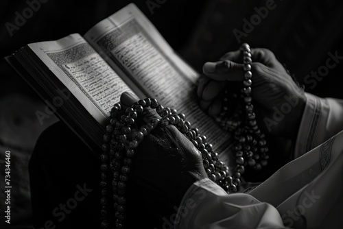 A man reading from the Qur'an with beads in hand during Ramadan.